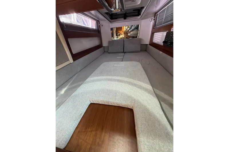 Yacht Photos Pics 2019 Axopar 28 Cabin interior with cozy seating and modern design.