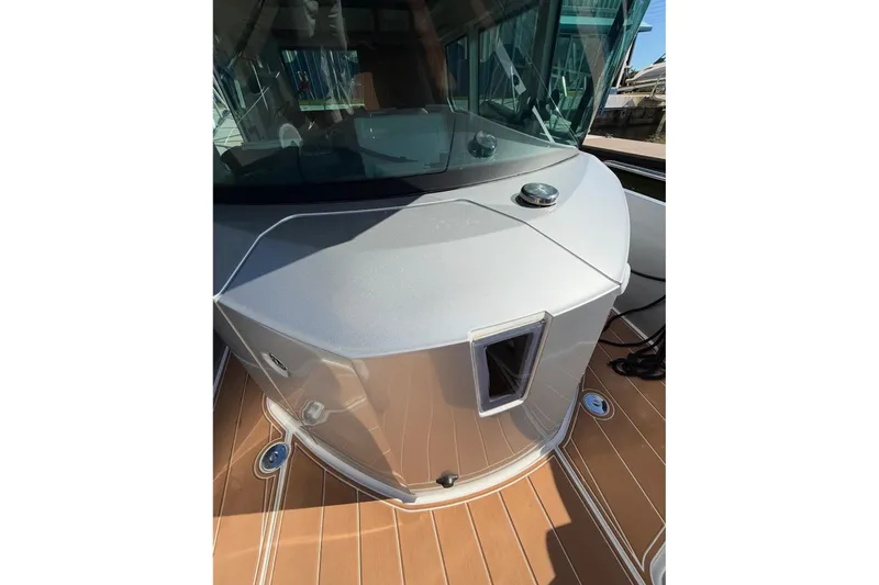  Yacht Photos Pics 2019 Axopar 28 Cabin boat with sleek design and wooden deck details.