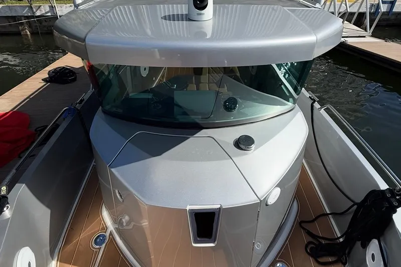  Yacht Photos Pics 2019 Axopar 28 Cabin boat docked, featuring sleek design and modern cabin.