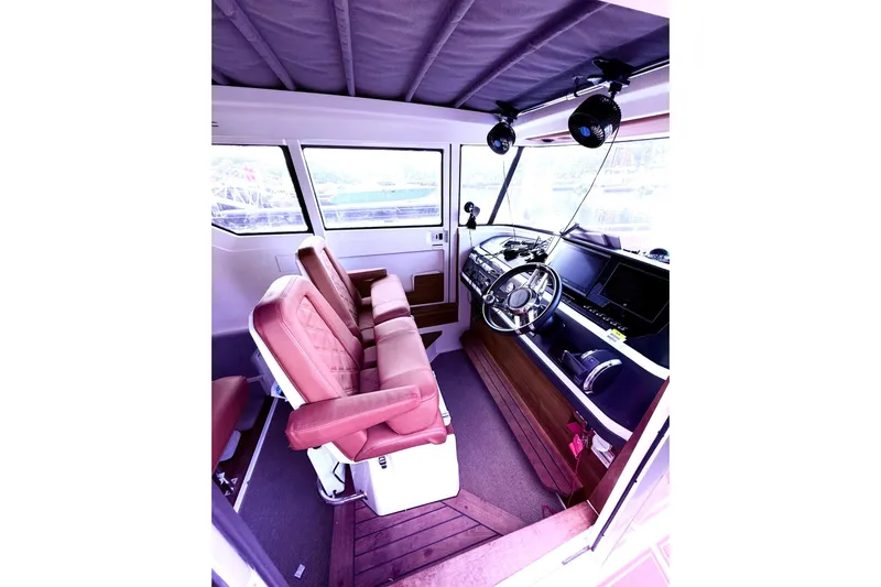  Yacht Photos Pics Interior of 2019 Axopar 28 Cabin boat with leather seats and modern dashboard.