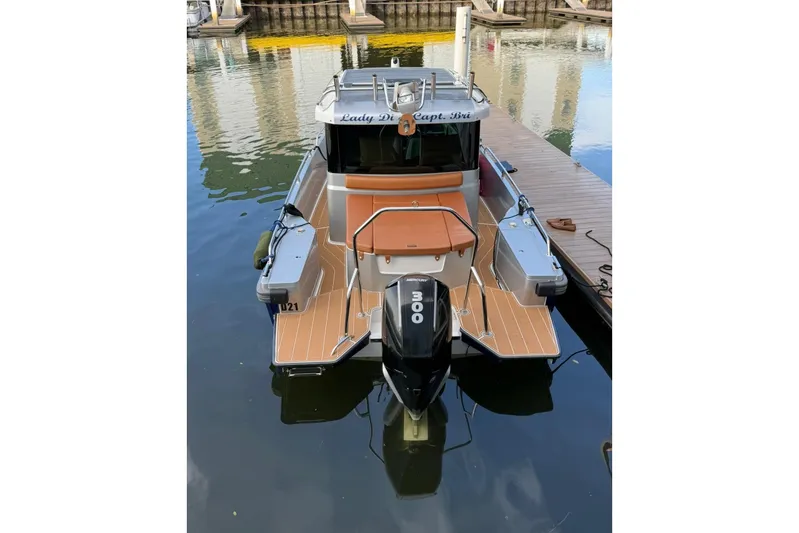  Yacht Photos Pics 2019 Axopar 28 Cabin boat docked, featuring a 300 horsepower outboard motor.