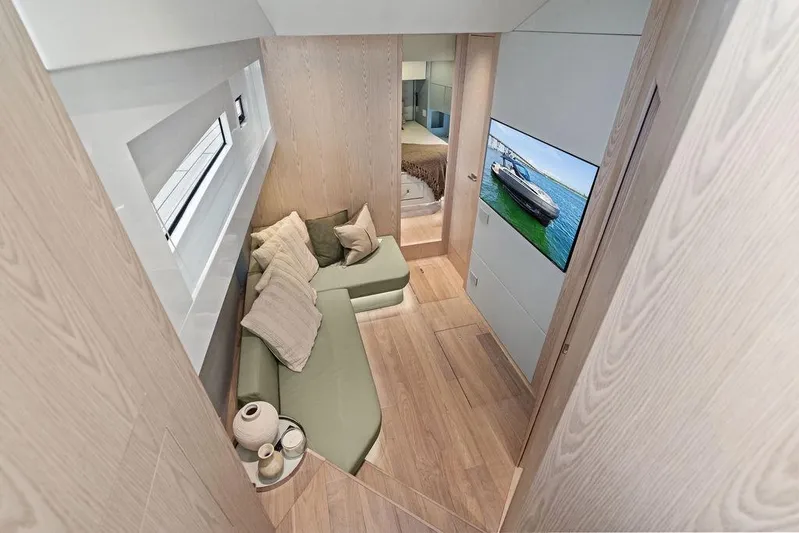  Yacht Photos Pics Luxurious interior of 2026 SACS Rebel 55 yacht with modern seating and wall-mounted TV.