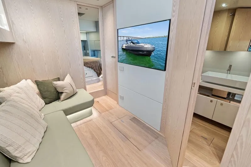  Yacht Photos Pics Luxurious interior of 2026 SACS Rebel 55 yacht with modern furnishings and TV display.