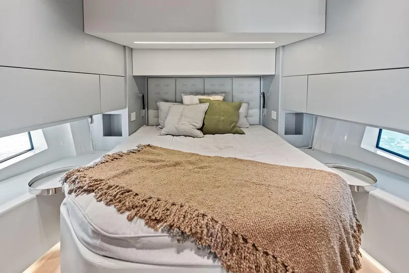  Yacht Photos Pics Luxurious bedroom interior of 2026 SACS Rebel 55 yacht with cozy bedding.