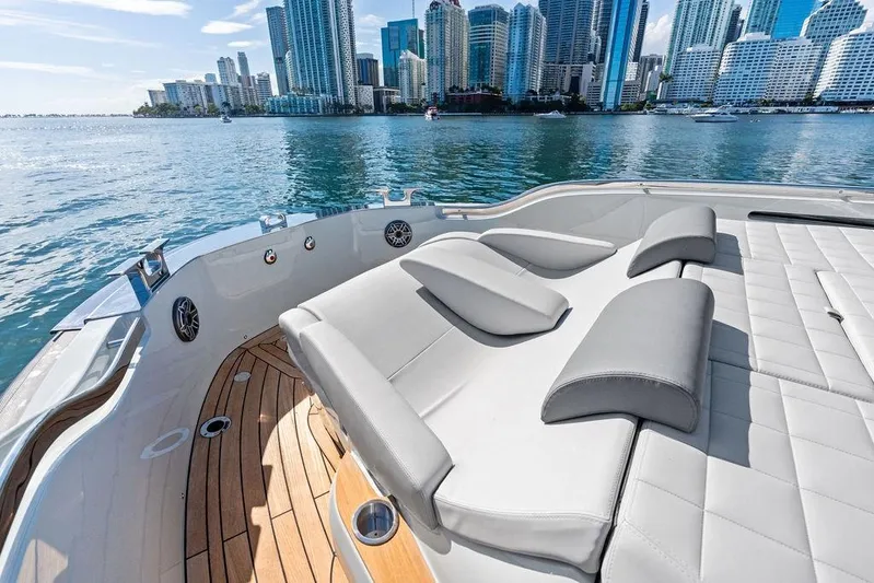  Yacht Photos Pics Luxurious 2026 SACS Rebel 55 yacht with city skyline view, featuring elegant deck seating.