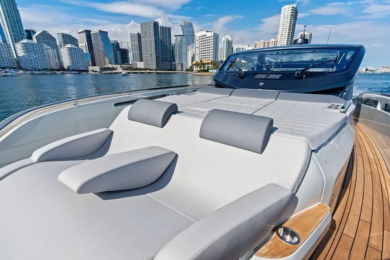  Yacht Photos Pics Luxurious 2026 SACS Rebel 55 yacht with city skyline backdrop, featuring sleek design and spacious deck.