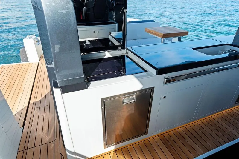  Yacht Photos Pics Luxury outdoor kitchen on 2026 SACS Rebel 55 yacht with sleek design and ocean view.