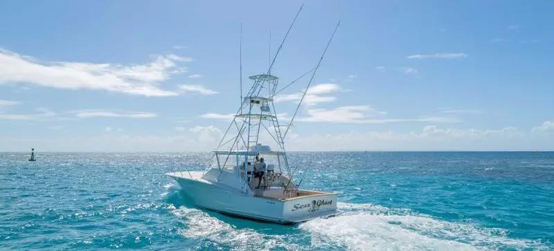 Sea Ghost Yacht Photos Pics 2008 Spencer Custom Carolina Express boat cruising on clear blue ocean waters.