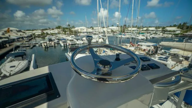 Sea Ghost Yacht Photos Pics Steering wheel of 2008 Spencer Custom Carolina Express yacht overlooking marina.