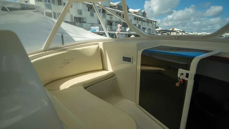 Sea Ghost Yacht Photos Pics 2008 Spencer Custom Carolina Express boat interior with beige seating and marina view.