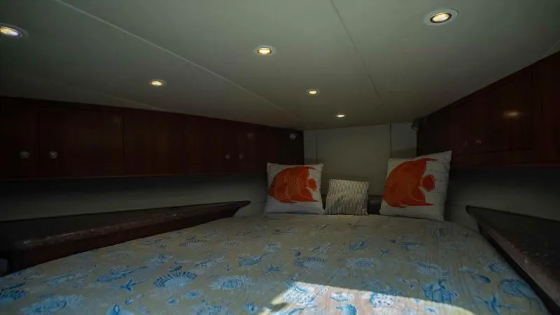 Sea Ghost Yacht Photos Pics Interior cabin of 2008 Spencer Custom Carolina Express with cozy bedding and decorative pillows.