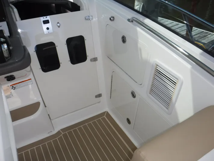  Yacht Photos Pics 2008 Boston Whaler 345 Conquest interior with storage compartments and beige seating.