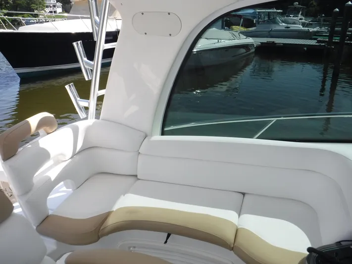  Yacht Photos Pics 2008 Boston Whaler 345 Conquest interior with white seating, docked boats visible outside.
