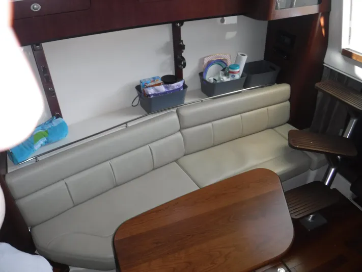  Yacht Photos Pics Interior of 2008 Boston Whaler 345 Conquest with beige seating and wooden table.