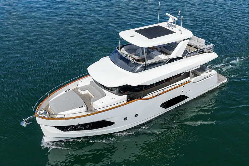  Yacht Photos Pics 2024 Absolute 58 Navetta yacht cruising on open water, showcasing sleek design and luxury features.