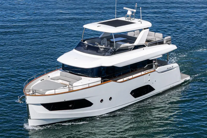  Yacht Photos Pics 2024 Absolute 58 Navetta yacht cruising on open water, showcasing sleek design and luxury features.