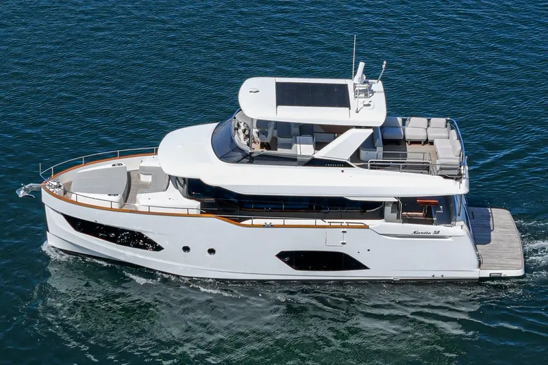  Yacht Photos Pics 2024 Absolute 58 Navetta yacht cruising on blue water, showcasing sleek design and luxury features.