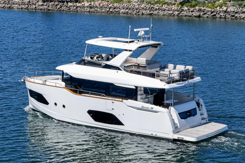  Yacht Photos Pics 2024 Absolute 58 Navetta luxury yacht cruising on a calm blue sea.