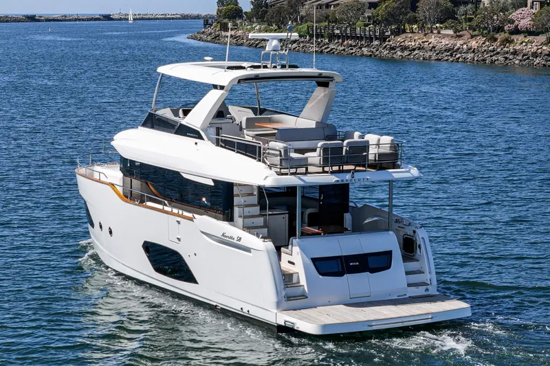  Yacht Photos Pics 2024 Absolute 58 Navetta yacht cruising on a serene waterway, showcasing luxury and elegance.