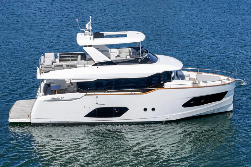  Yacht Photos Pics 2024 Absolute 58 Navetta yacht on calm blue water, side view.