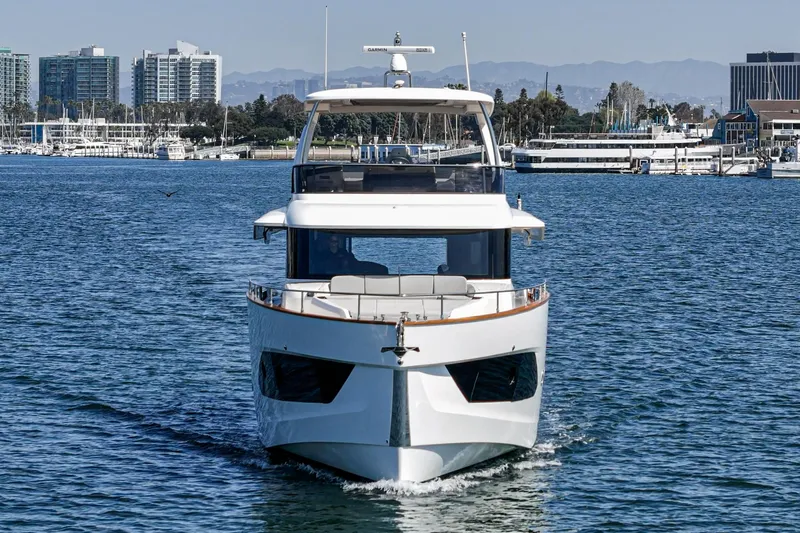  Yacht Photos Pics 2024 Absolute 58 Navetta yacht cruising in a marina with cityscape background.