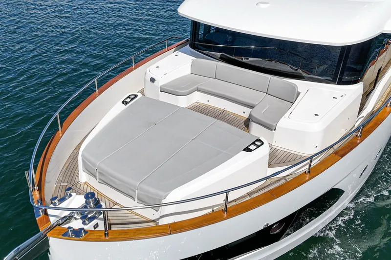  Yacht Photos Pics 2024 Absolute 58 Navetta yacht with spacious deck and seating area on the water.
