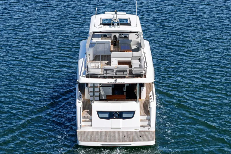  Yacht Photos Pics 2024 Absolute 58 Navetta yacht cruising on open water, rear view.