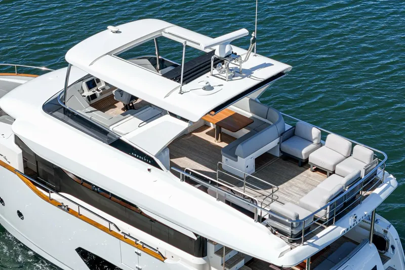  Yacht Photos Pics 2024 Absolute 58 Navetta yacht with spacious deck and modern design on the water.
