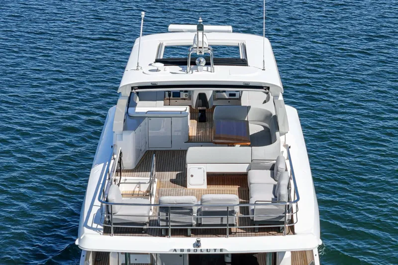  Yacht Photos Pics 2024 Absolute 58 Navetta yacht on water, showcasing spacious deck and modern design.