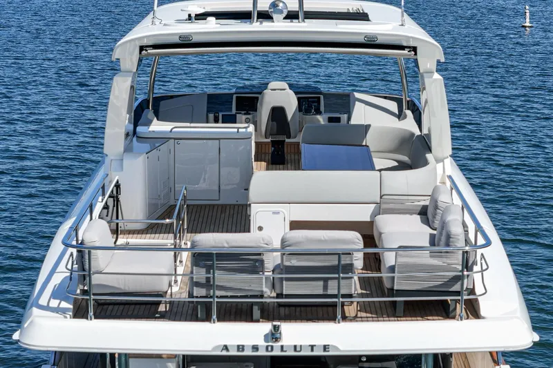  Yacht Photos Pics 2024 Absolute 58 Navetta yacht with spacious deck and seating, cruising on calm blue waters.