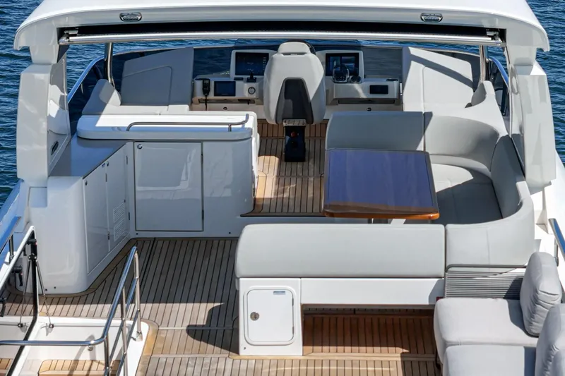  Yacht Photos Pics Luxurious 2024 Absolute 58 Navetta yacht deck with seating and helm station.