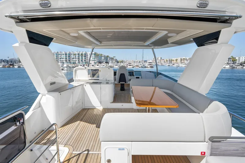  Yacht Photos Pics Luxurious 2024 Absolute 58 Navetta yacht with spacious deck and modern seating area.