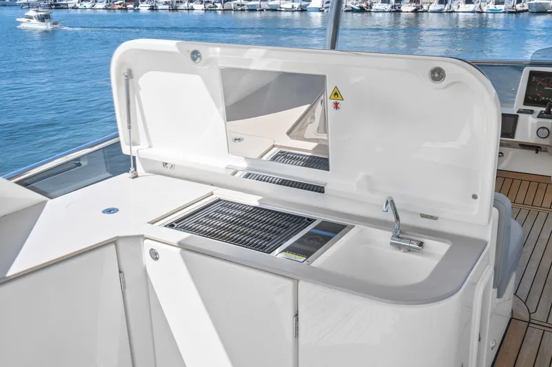  Yacht Photos Pics Outdoor kitchen on 2024 Absolute 58 Navetta yacht, featuring grill and sink.