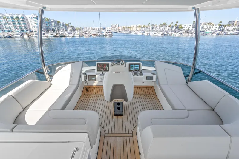  Yacht Photos Pics 2024 Absolute 58 Navetta yacht helm with luxurious seating and marina view.