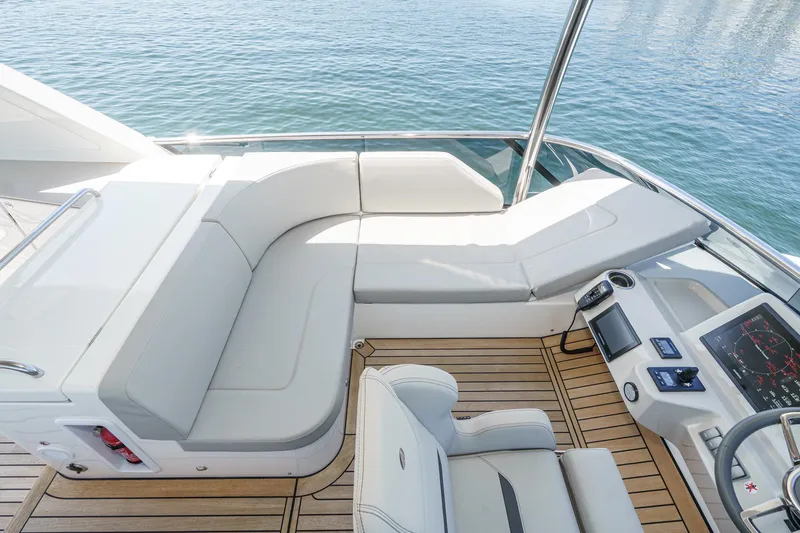  Yacht Photos Pics Luxurious seating area on 2024 Absolute 58 Navetta yacht with sleek design and modern controls.