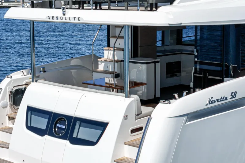  Yacht Photos Pics 2024 Absolute 58 Navetta yacht, featuring sleek design and luxurious outdoor seating area.