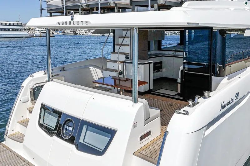  Yacht Photos Pics 2024 Absolute 58 Navetta yacht, featuring a sleek design and spacious deck area.