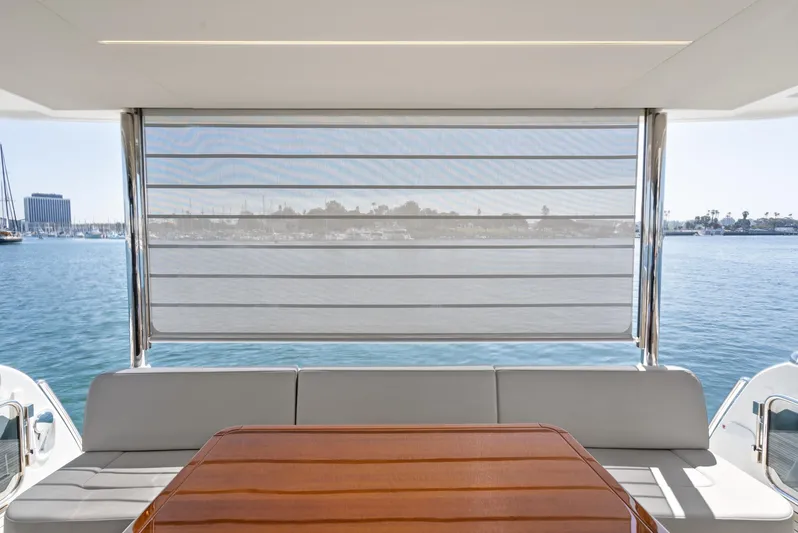  Yacht Photos Pics 2024 Absolute 58 Navetta yacht with shaded seating area overlooking serene water.