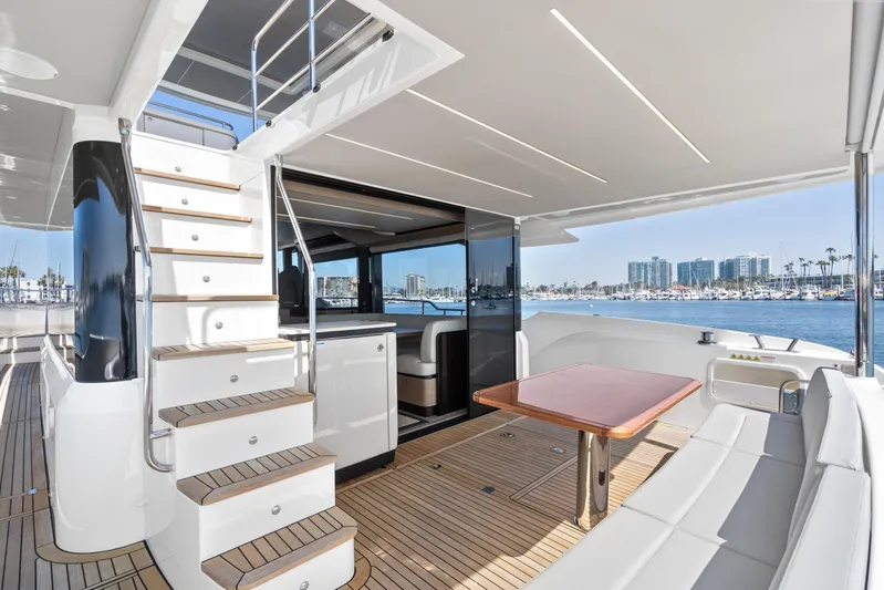  Yacht Photos Pics Luxurious 2024 Absolute 58 Navetta yacht interior with elegant seating and scenic marina view.