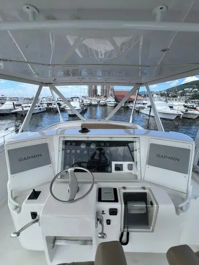 Play Pen Yacht Photos Pics Bertram 510 Convertible 2001 yacht helm with Garmin navigation, docked at marina.