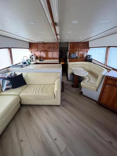 Play Pen Yacht Photos Pics Interior of 2001 Bertram 510 Convertible yacht with beige seating and wooden cabinetry.