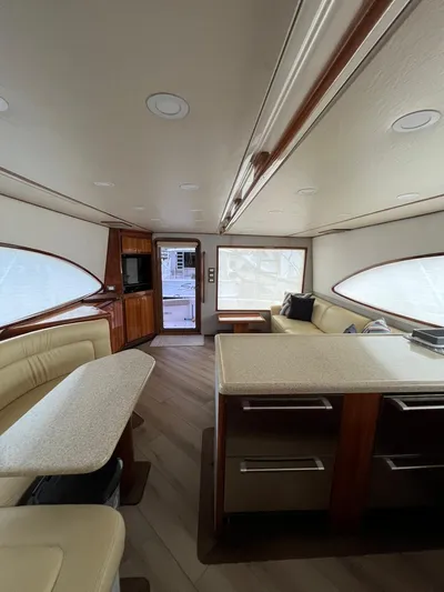 Play Pen Yacht Photos Pics Interior of a 2001 Bertram 510 Convertible yacht with modern furnishings and ample seating.