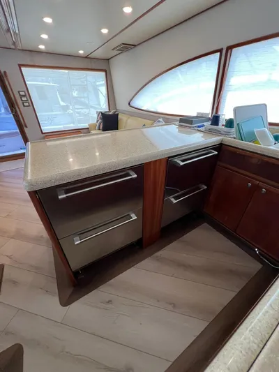 Play Pen Yacht Photos Pics Interior of 2001 Bertram 510 Convertible yacht with modern kitchen and sleek cabinetry.