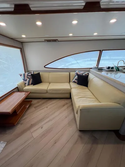 Play Pen Yacht Photos Pics Interior of 2001 Bertram 510 Convertible yacht with beige leather seating and wooden accents.