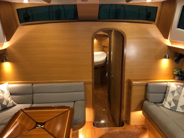 Pneumatic Yacht Photos Pics Luxurious interior of 2020 Bluewater 56 yacht with elegant wood finish and cozy seating.