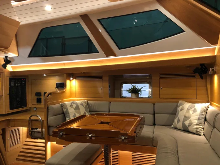 Pneumatic Yacht Photos Pics Luxurious interior of 2020 Bluewater 56 yacht with modern seating and ambient lighting.