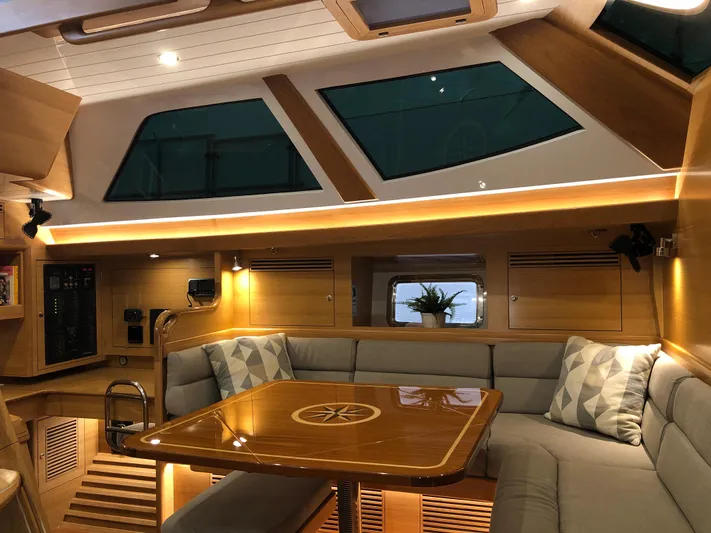 Pneumatic Yacht Photos Pics Luxurious interior of 2020 Bluewater 56 yacht with elegant wood finish and plush seating.