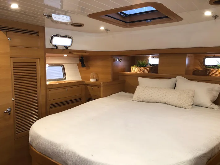 Pneumatic Yacht Photos Pics Luxurious cabin interior of 2020 Bluewater 56 yacht with cozy bed and wooden finish.