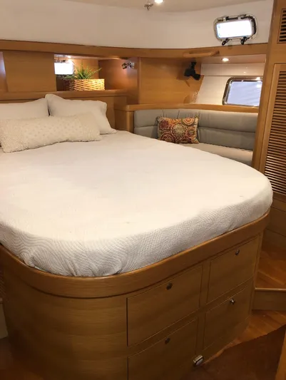 Pneumatic Yacht Photos Pics Luxurious cabin interior of 2020 Bluewater 56 yacht with cozy bed and seating area.