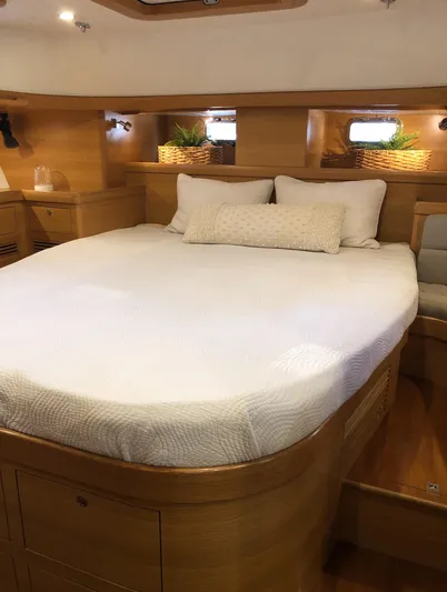 Pneumatic Yacht Photos Pics Luxurious cabin interior of 2020 Bluewater 56 yacht with cozy bed and wooden finish.